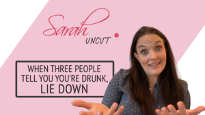 Picture of Sarah with wide eyes and the Sarah Uncut background for Episode 24 background with two hand face up shoulder length apart