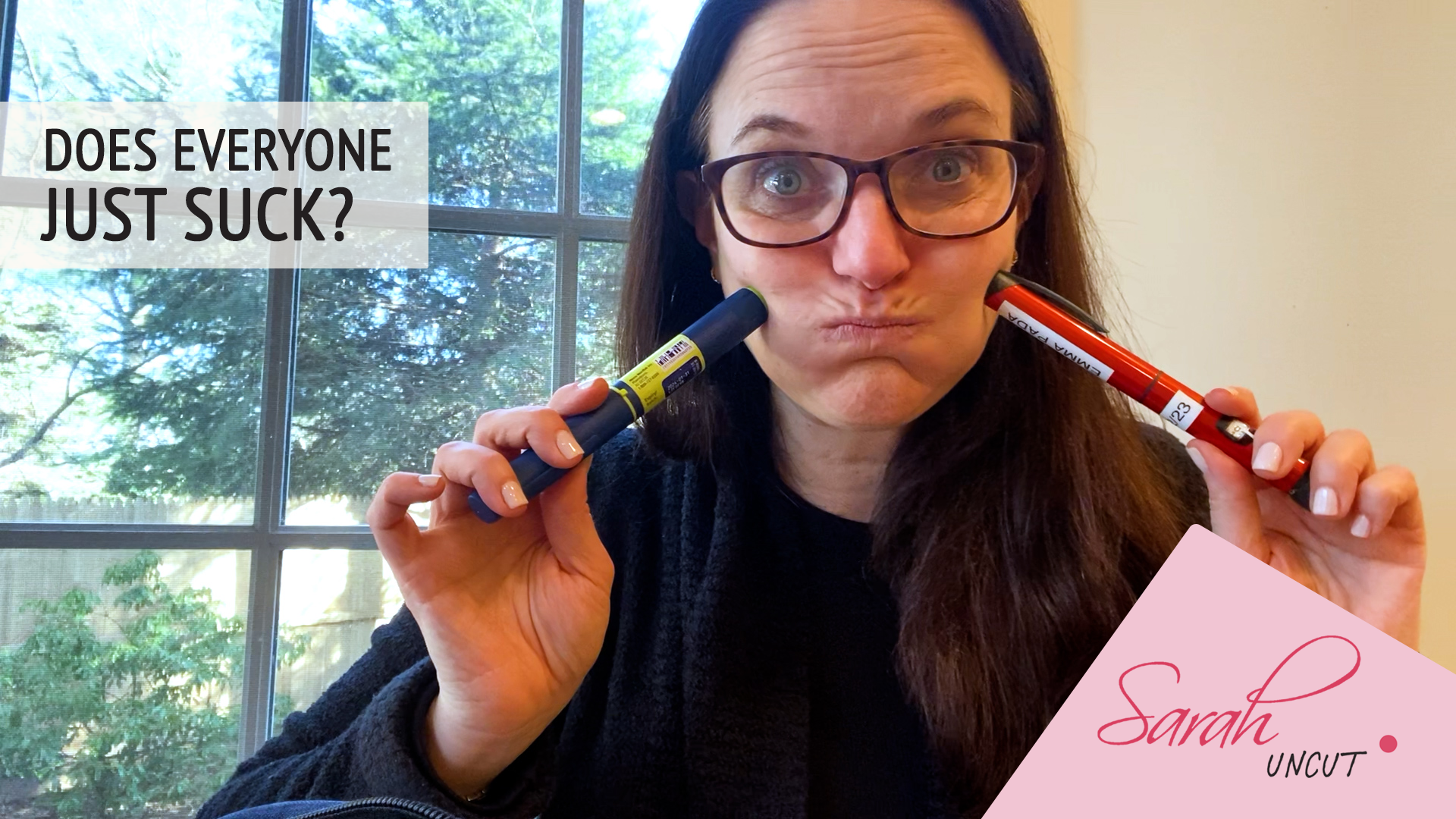 Picture of Sarah in black sweater pointing two pens into each of her cheeks. Text reads: Does Everyone Just Suck. Sarah Uncut.