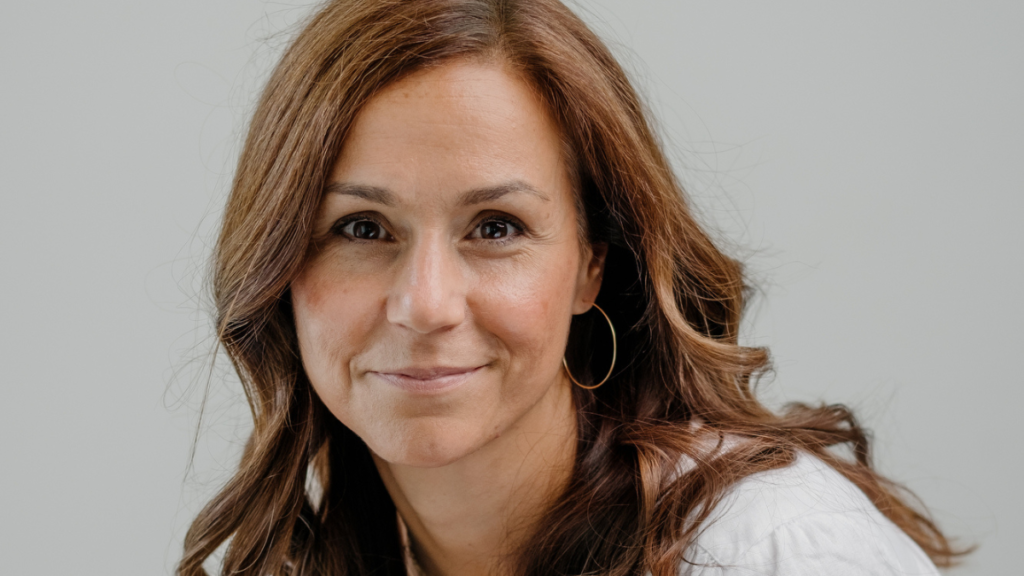 Woman in white t-shirt and gold hoop earrings
