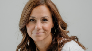 Woman in white t-shirt and gold hoop earrings