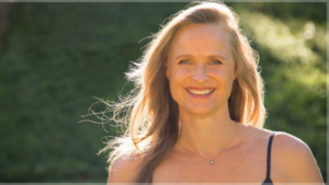 Woman in black tank top in front of trees with text What's life really like after menopause with Dr. Cari Schaefer on The Game On Girlfriend Podcast with Sarah Walton