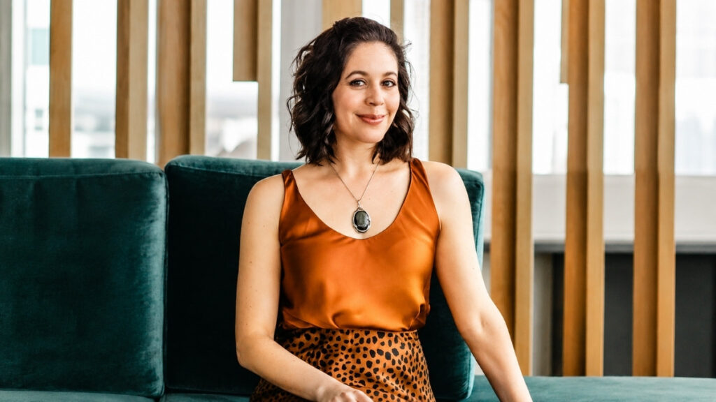 Rachel Loewenherz, Yale-educated business strategist and founder of Star Path, smiling on a teal couch