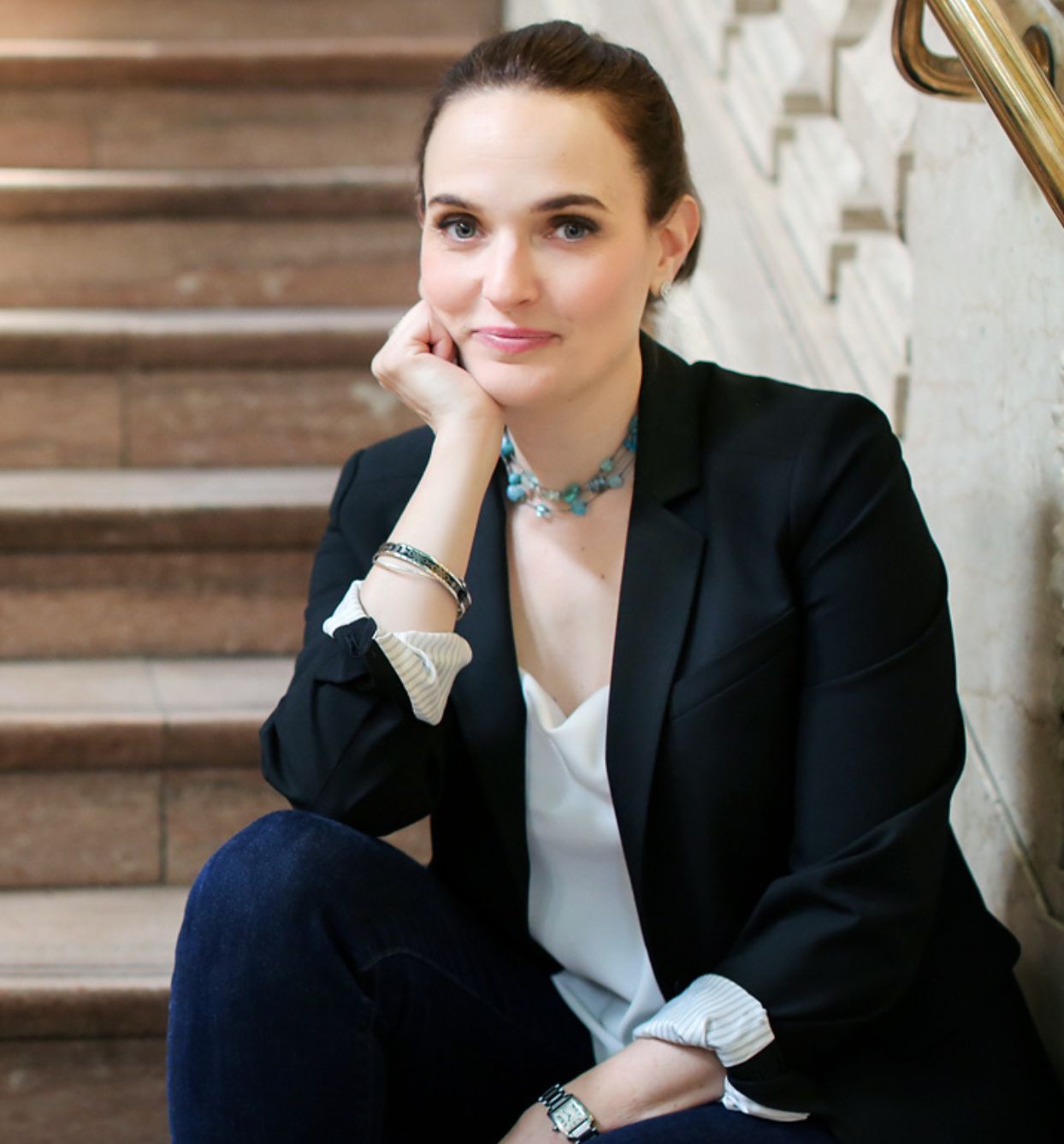 Meet Sarah - your new business coach - wearing black blazer and blue slacks