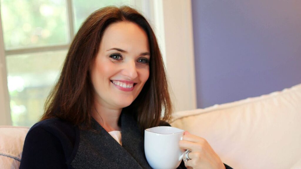 Woman entrepreneur journaling with coffee during year-end reflection