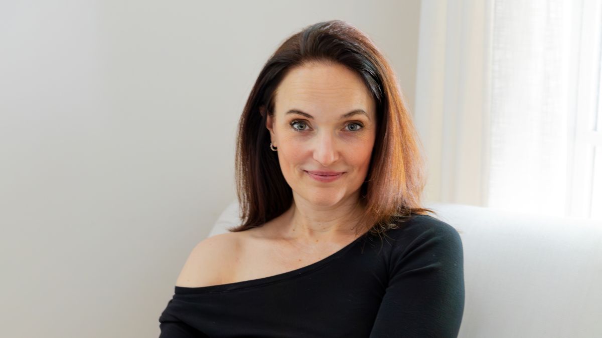 Woman entrepreneur journaling with coffee during year-end reflection