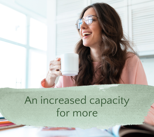 Your alt text is very thorough, but you can drop "photo of" and tighten it slightly: ALT TEXT (improved): "Woman holding coffee cup smiling open-mouthed at her desk, wearing pink sweatshirt, looking out window with magazines and white background"