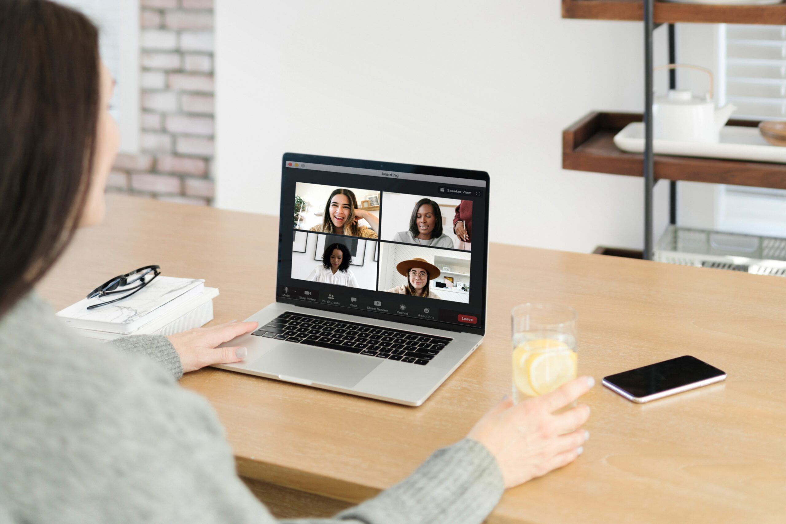 Woman participating in live group video coaching call with other women entrepreneurs