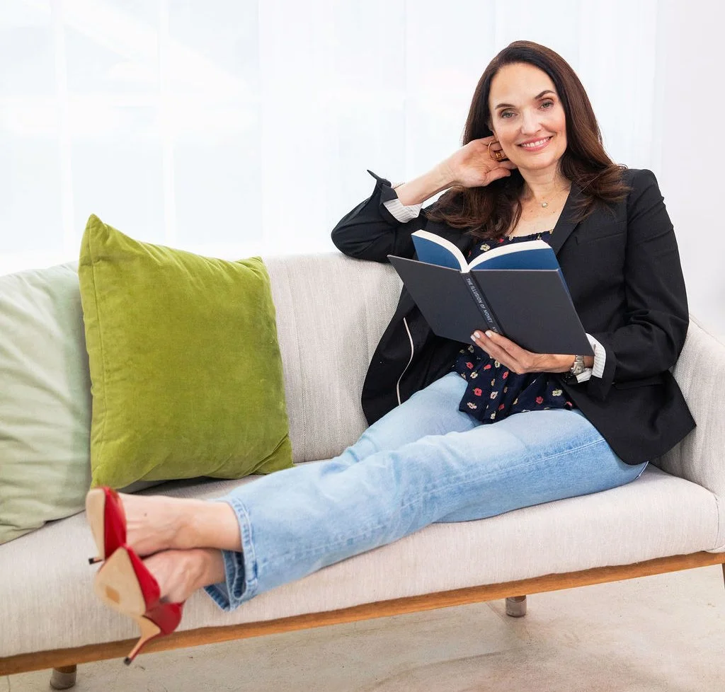 Sarah Walton sitting on a couch in a bright living room