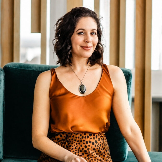 Rachel Loewenherz, Yale-educated business strategist and founder of Star Path, smiling on a teal couch