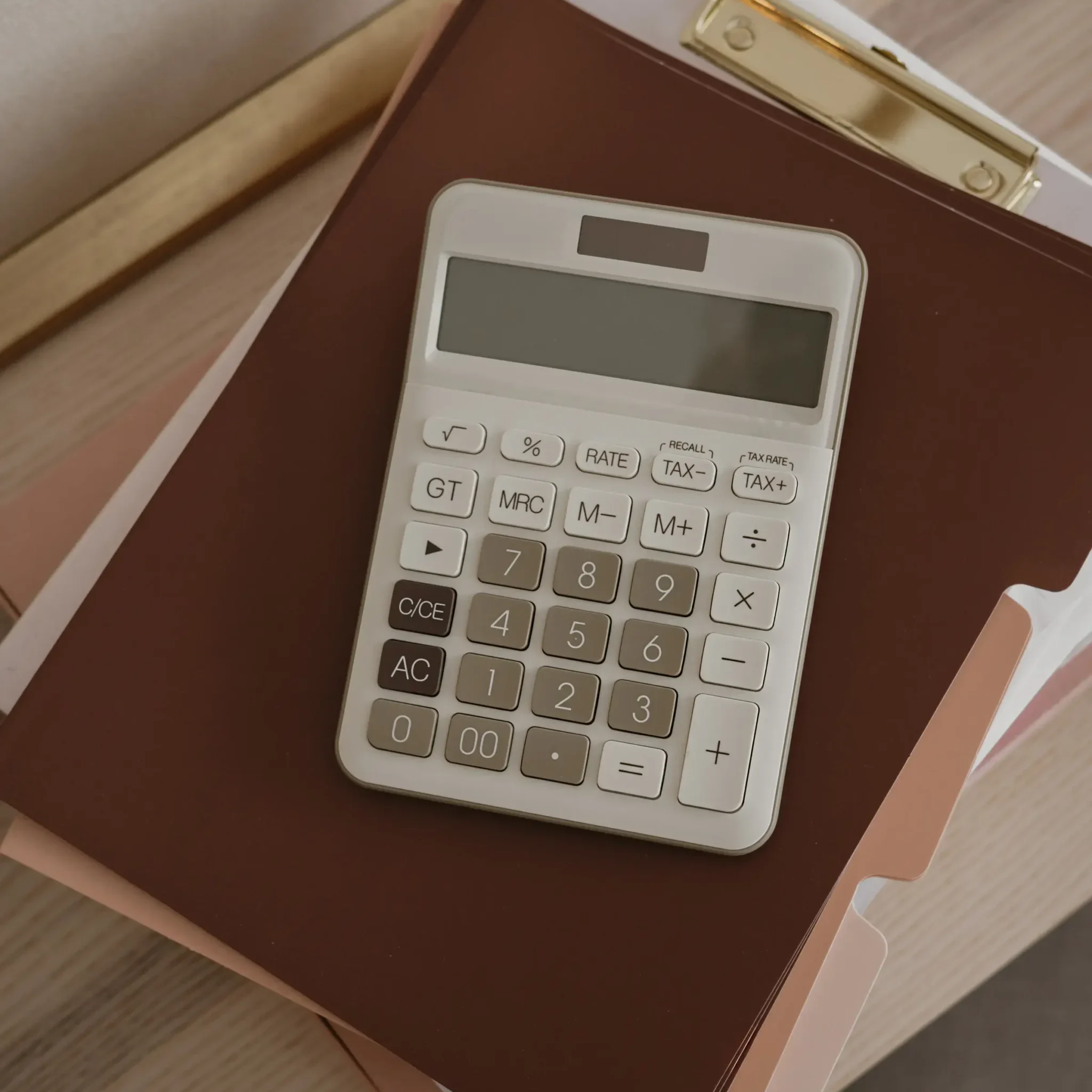Analog calculator on a stack of folders