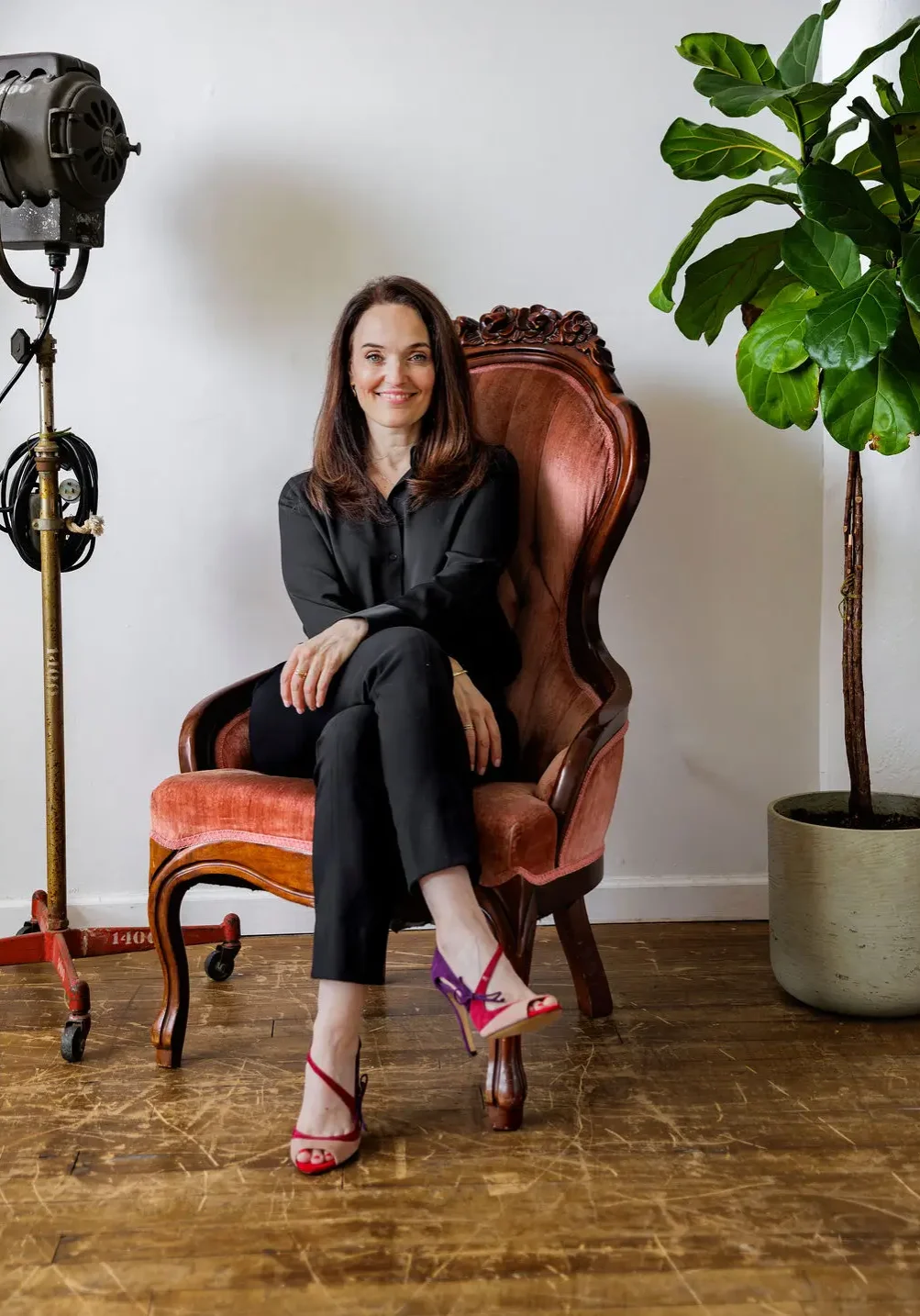 Sarah Walton sitting on an ornate pink chair - Wealth Consciousness