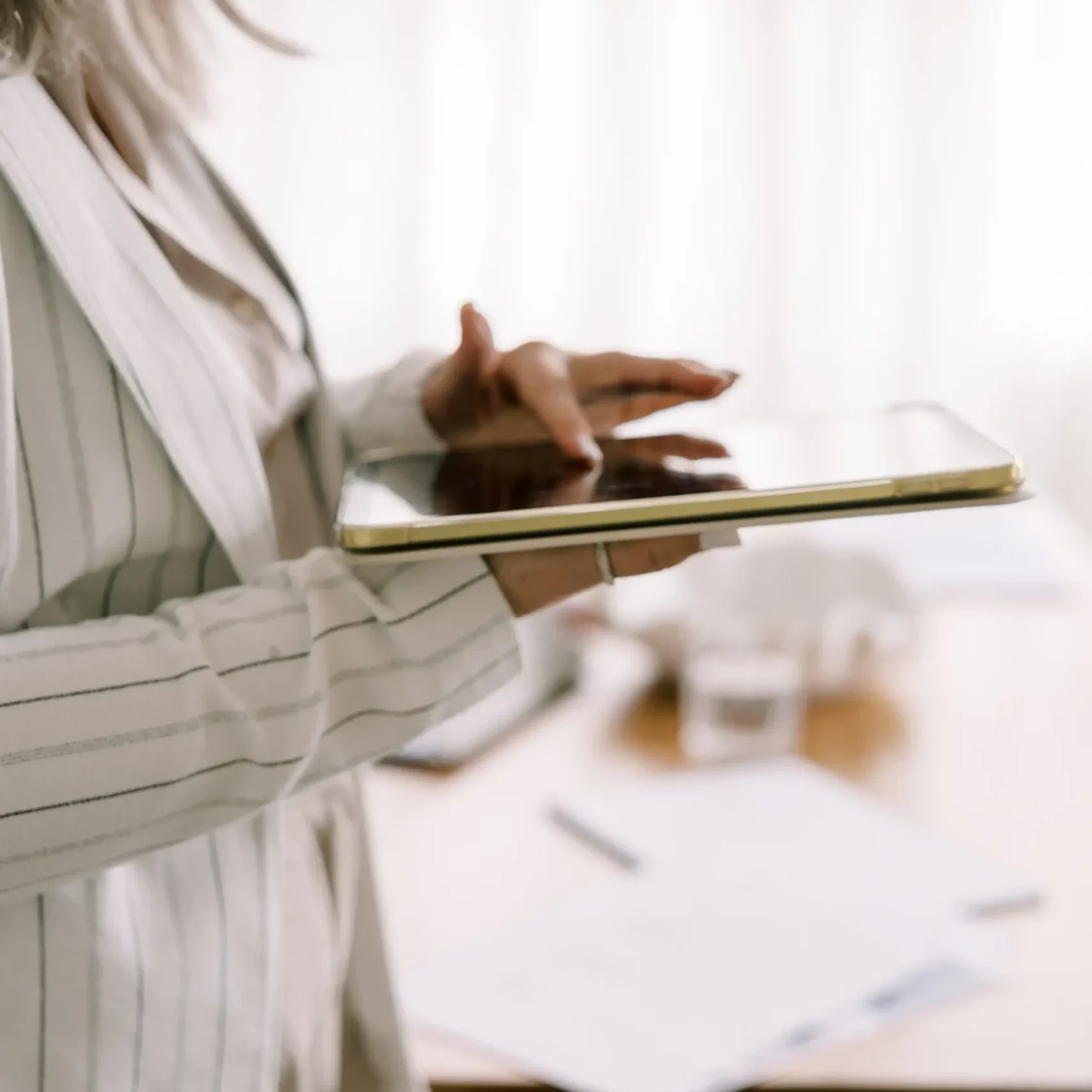 Woman on iPad in a bright white room